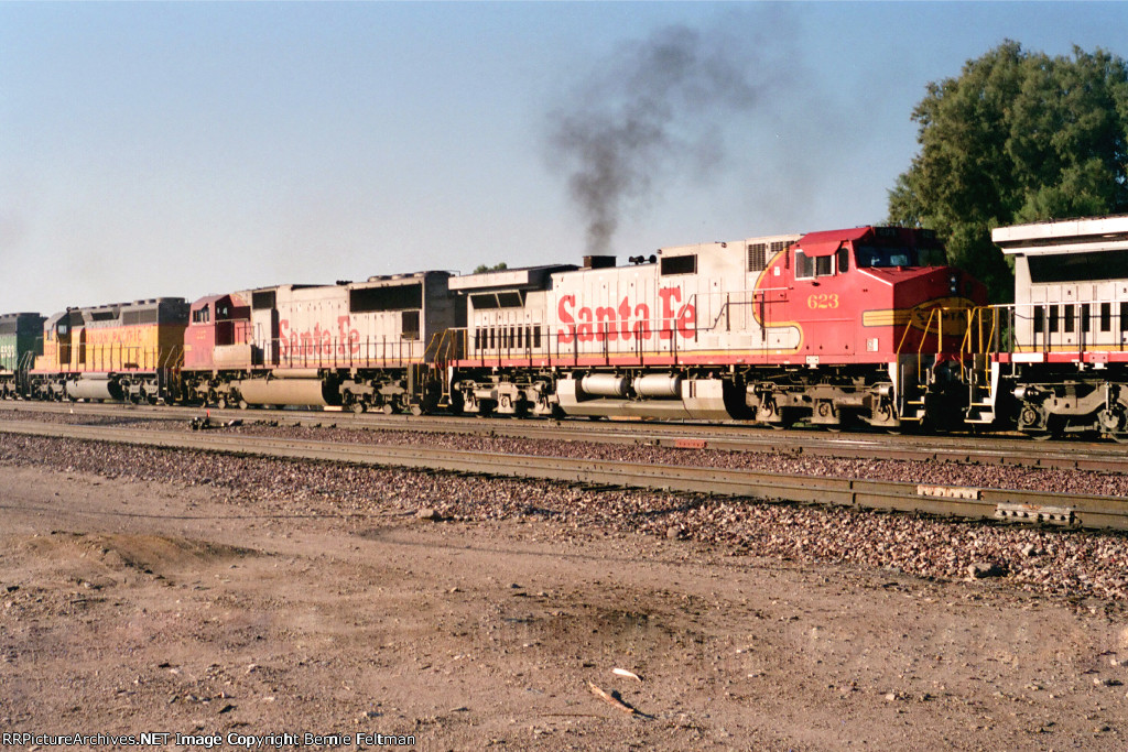 Santa Fe C44-9W #623, in the consist of a westbound, passes the depot  